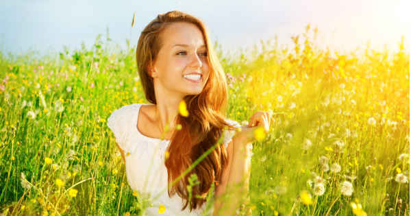 confident woman sitting in field