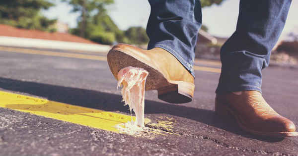 man stepping on a chewing gum on road